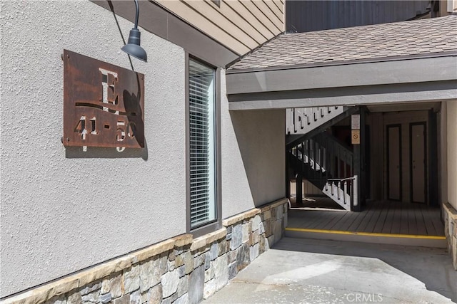 362 Old Mammoth Rd Unit 47, Mammoth Lakes, CA 93546 - property entrance featuring stone siding, stucco siding, and roof with shingles