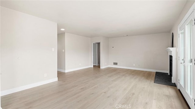 1466 Balboa St, San Luis Obispo, CA 93405 - spare room featuring light wood-style floors, a fireplace with raised hearth, recessed lighting, and healthy amount of natural light