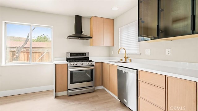 1466 Balboa St, San Luis Obispo, CA 93405 - kitchen featuring stainless steel appliances, wall chimney exhaust hood, light brown cabinetry, light countertops, and light wood-style floors