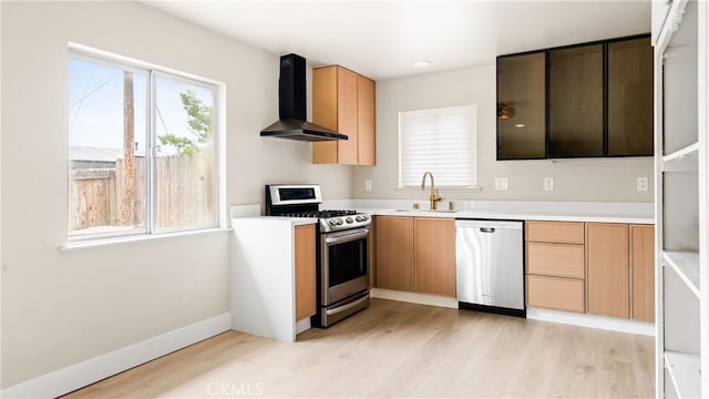 1466 Balboa St, San Luis Obispo, CA 93405 - kitchen featuring appliances with stainless steel finishes, wall chimney range hood, light wood-style floors, and light countertops