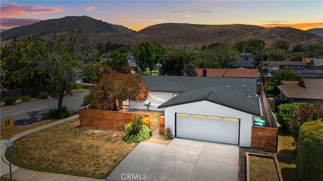 1466 Balboa St, San Luis Obispo, CA 93405 - view of front of home with a mountain view, stucco siding, an attached garage, concrete driveway, and roof with shingles