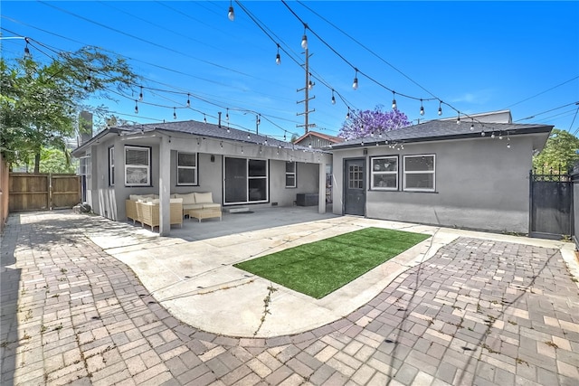1640 Magnolia Ave, Long Beach, CA 90813 - back of property with an outdoor living space, stucco siding, a fenced backyard, a patio, and a shingled roof