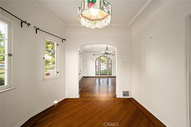 1161 N Everett St, Glendale, CA 91207 - corridor with arched walkways, a chandelier, wood finished floors, and ornamental molding