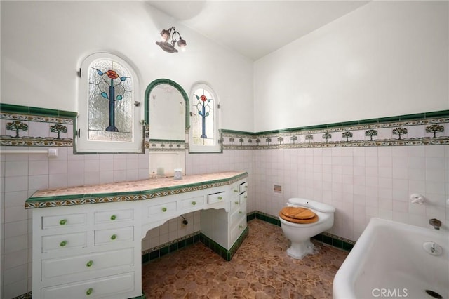 1161 N Everett St, Glendale, CA 91207 - bathroom with tile walls, a bathtub, and wainscoting