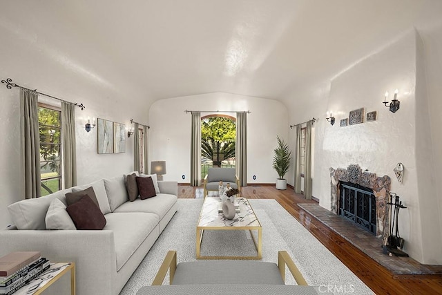 1161 N Everett St, Glendale, CA 91207 - living area with a fireplace with raised hearth, wood finished floors, healthy amount of natural light, and lofted ceiling