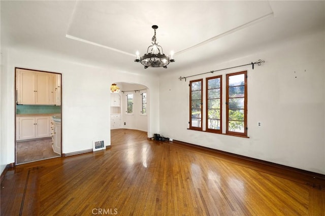 1161 N Everett St, Glendale, CA 91207 - unfurnished room with arched walkways, a chandelier, and wood finished floors