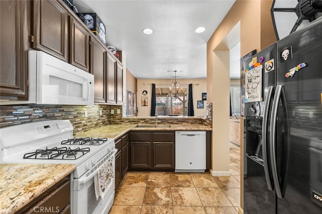 1706 Regents St, Lancaster, CA 93534 - kitchen with white appliances, dark brown cabinetry, a chandelier, tasteful backsplash, and recessed lighting