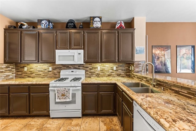 1706 Regents St, Lancaster, CA 93534 - kitchen featuring white appliances, backsplash, and dark brown cabinets