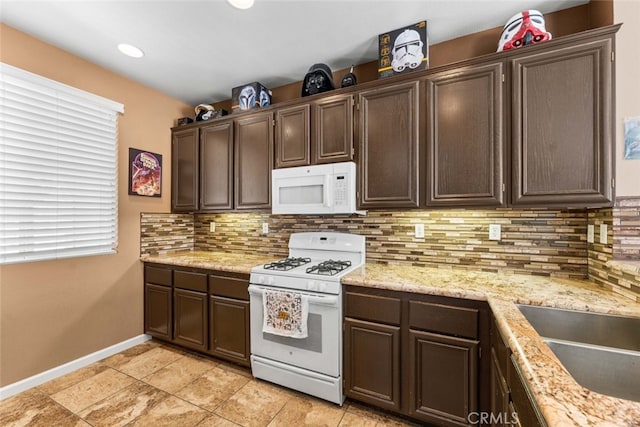 1706 Regents St, Lancaster, CA 93534 - kitchen featuring white appliances, dark brown cabinets, and decorative backsplash