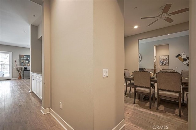 13471 Planet Ct, Riverside, CA 92503 - hallway with baseboards and light wood-style flooring