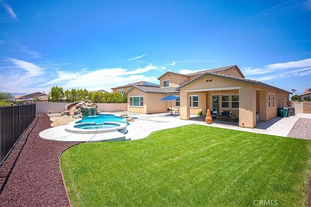 13471 Planet Ct, Riverside, CA 92503 - back of property with stucco siding, a fenced backyard, a patio, and a pool with connected hot tub