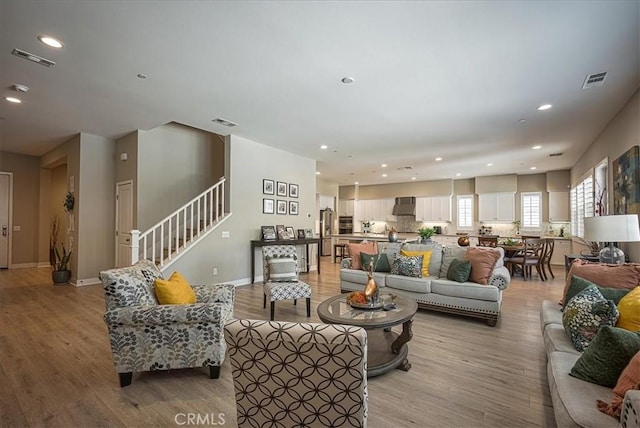 13471 Planet Ct, Riverside, CA 92503 - living room featuring recessed lighting, light wood-style floors, and stairs