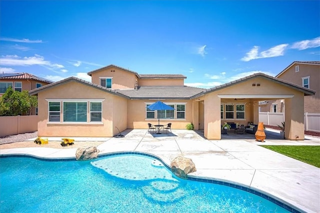 13471 Planet Ct, Riverside, CA 92503 - back of property with stucco siding, a fenced backyard, a patio, and outdoor lounge area