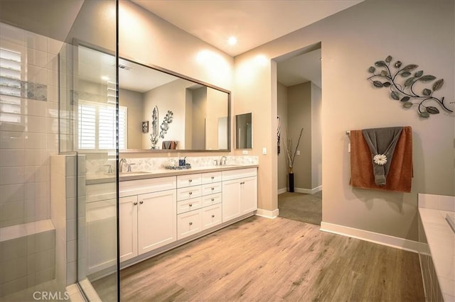 13471 Planet Ct, Riverside, CA 92503 - bathroom with double vanity, wood finished floors, a tile shower, and a tub