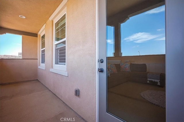13471 Planet Ct, Riverside, CA 92503 - property entrance with stucco siding and a balcony