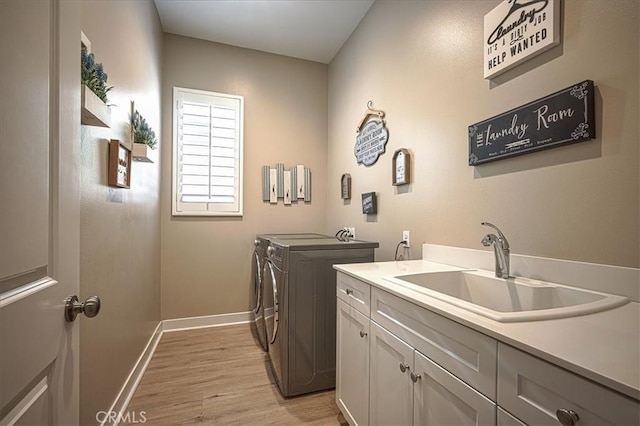 13471 Planet Ct, Riverside, CA 92503 - laundry room featuring separate washer and dryer, light wood-type flooring, and cabinet space