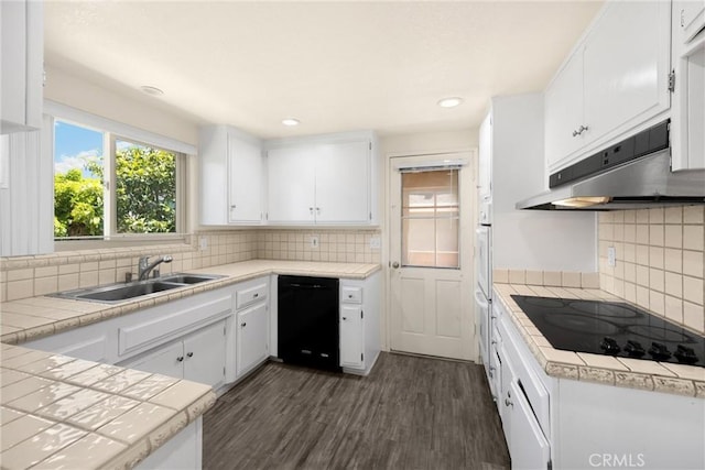 17342 Almelo Ln, Huntington Beach, CA 92649 - kitchen featuring black appliances, under cabinet range hood, white cabinetry, tasteful backsplash, and recessed lighting