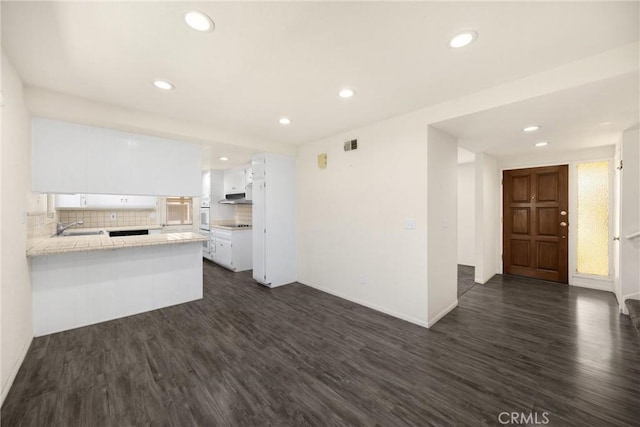 17342 Almelo Ln, Huntington Beach, CA 92649 - kitchen featuring white cabinets, dark wood finished floors, recessed lighting, and backsplash