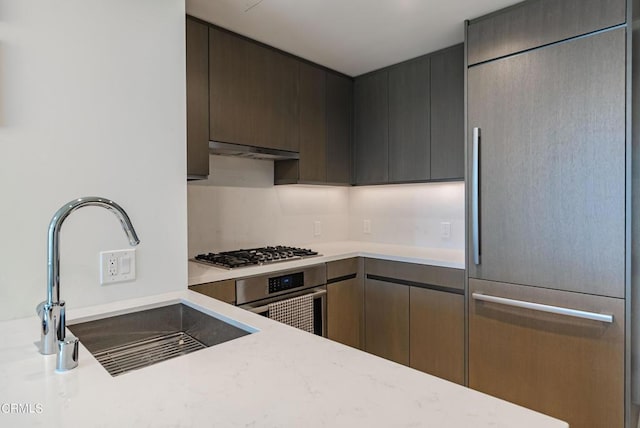 889 Francisco St Unit 802, Los Angeles, CA 90017 - kitchen featuring appliances with stainless steel finishes, under cabinet range hood, modern cabinets, and light stone counters