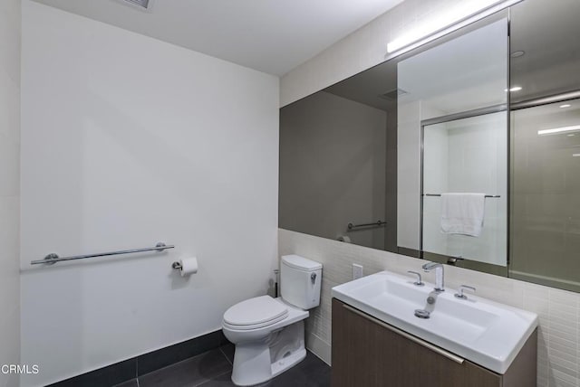 889 Francisco St Unit 802, Los Angeles, CA 90017 - bathroom with tile walls, vanity, tile patterned flooring, and a shower