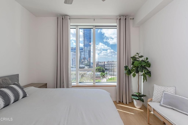 889 Francisco St Unit 802, Los Angeles, CA 90017 - bedroom with multiple windows, ceiling fan, a view of city, and light wood-style floors