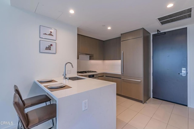 889 Francisco St Unit 802, Los Angeles, CA 90017 - kitchen featuring a peninsula, a kitchen bar, light countertops, modern cabinets, and recessed lighting