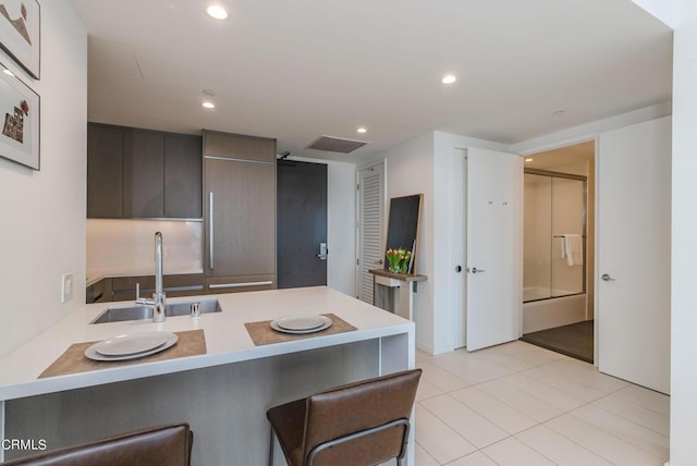 889 Francisco St Unit 802, Los Angeles, CA 90017 - kitchen featuring a kitchen breakfast bar, a peninsula, dark brown cabinetry, recessed lighting, and modern cabinets