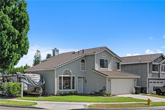 1365 Kroonen Dr, Corona, CA 92882 - traditional-style home featuring a tile roof, driveway, a chimney, an attached garage, and a front lawn
