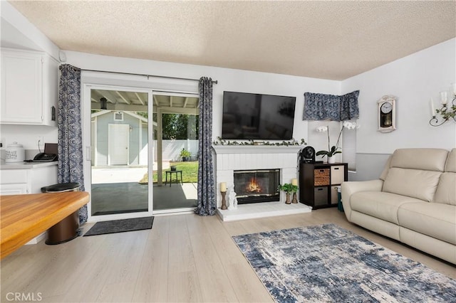 1365 Kroonen Dr, Corona, CA 92882 - living room featuring a textured ceiling, wood finished floors, and a brick fireplace