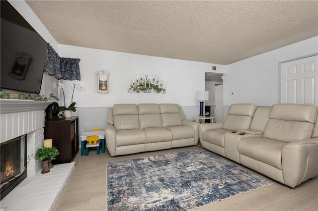 1365 Kroonen Dr, Corona, CA 92882 - living area featuring a brick fireplace and a textured ceiling
