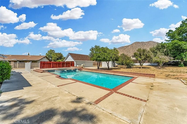 12887 Mount Vernon Ave, Grand Terrace, CA 92313 - view of pool with a pool with connected hot tub, a patio area, and a mountain view