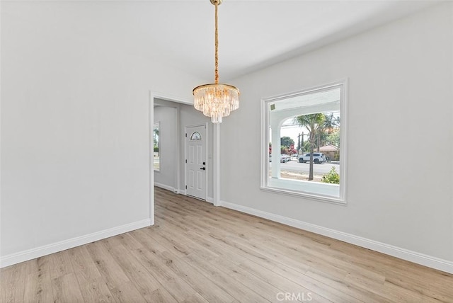 12887 Mount Vernon Ave, Grand Terrace, CA 92313 - unfurnished dining area with a chandelier and wood finished floors