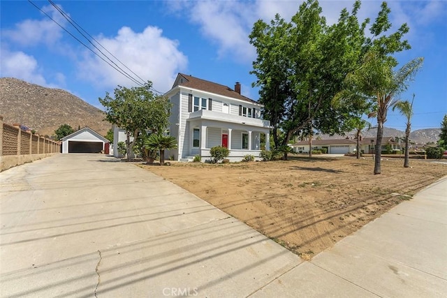 12887 Mount Vernon Ave, Grand Terrace, CA 92313 - view of front of property featuring a detached garage, a chimney, an outbuilding, covered porch, and a mountain view
