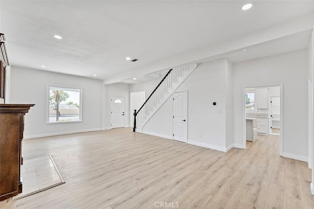 12887 Mount Vernon Ave, Grand Terrace, CA 92313 - unfurnished living room with light wood-type flooring, stairs, and recessed lighting