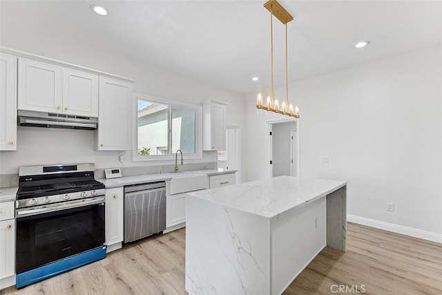 12887 Mount Vernon Ave, Grand Terrace, CA 92313 - kitchen featuring stainless steel appliances, under cabinet range hood, light wood-type flooring, white cabinets, and a kitchen island
