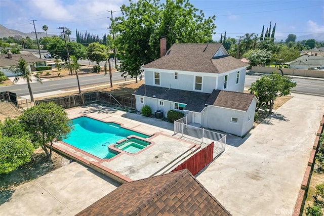12887 Mount Vernon Ave, Grand Terrace, CA 92313 - view of swimming pool with a fenced backyard, a pool with connected hot tub, and a patio area