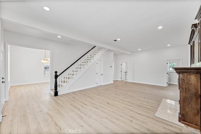 12887 Mount Vernon Ave, Grand Terrace, CA 92313 - unfurnished living room with stairway, light wood-style floors, recessed lighting, and a chandelier