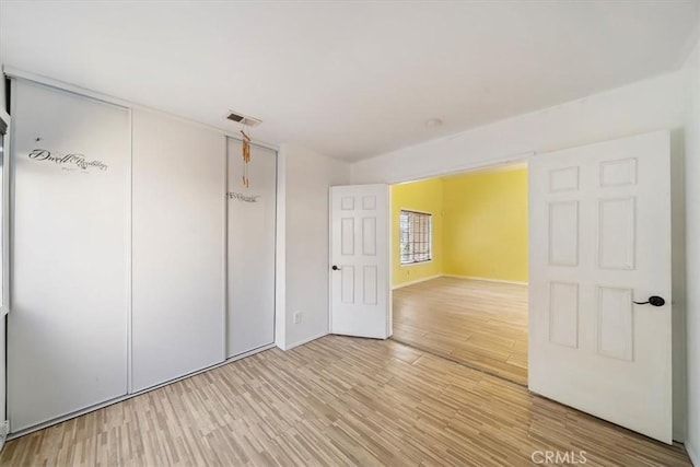 13969 Chervil Ct, Moreno Valley, CA 92553 - unfurnished bedroom with light wood-style floors and a closet