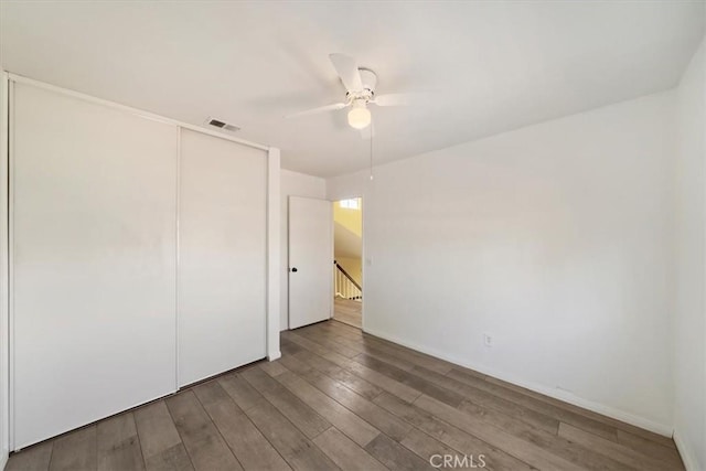 13969 Chervil Ct, Moreno Valley, CA 92553 - unfurnished bedroom with wood finished floors, a closet, and a ceiling fan