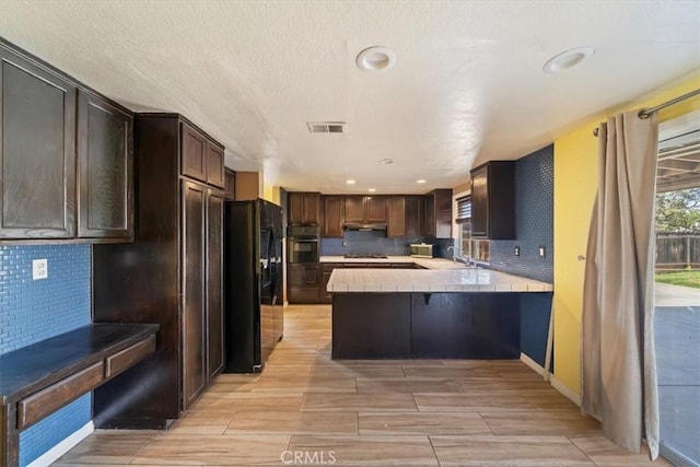 13969 Chervil Ct, Moreno Valley, CA 92553 - kitchen featuring black appliances, tile countertops, dark brown cabinetry, tasteful backsplash, and recessed lighting