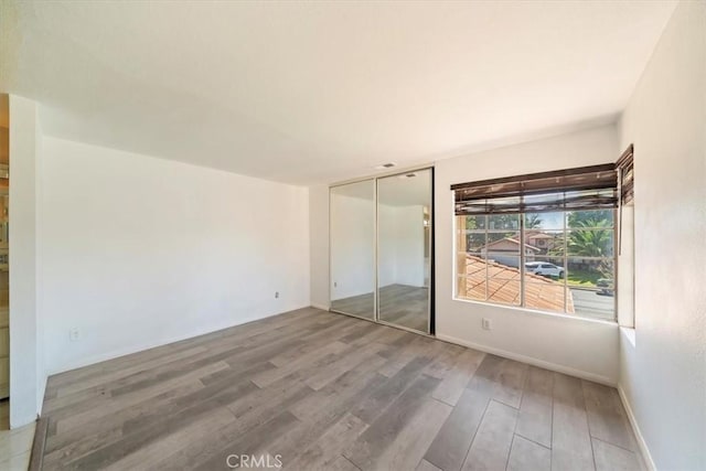 13969 Chervil Ct, Moreno Valley, CA 92553 - unfurnished bedroom with wood finished floors and a closet