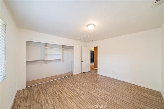 13969 Chervil Ct, Moreno Valley, CA 92553 - unfurnished bedroom featuring light wood finished floors, a closet, and multiple windows