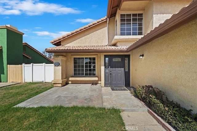 13969 Chervil Ct, Moreno Valley, CA 92553 - property entrance with stucco siding, a patio, and a tiled roof