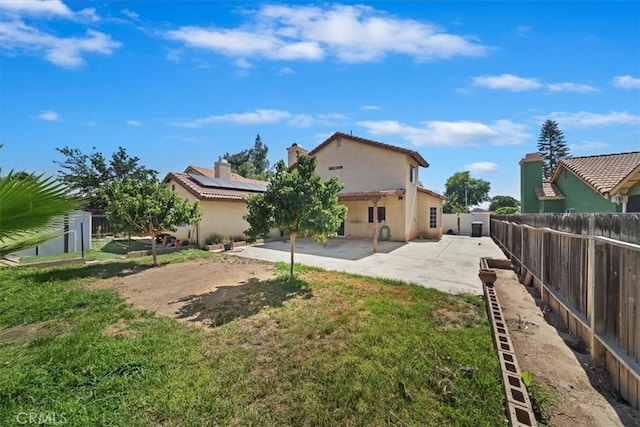 13969 Chervil Ct, Moreno Valley, CA 92553 - rear view of house featuring stucco siding, a patio area, a fenced backyard, a chimney, and a tile roof