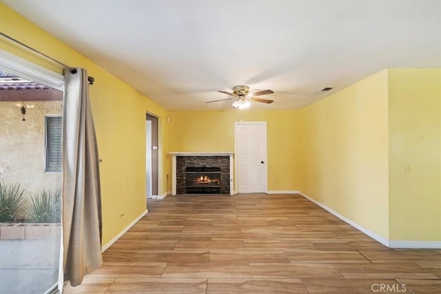 13969 Chervil Ct, Moreno Valley, CA 92553 - unfurnished living room featuring light wood-style floors, a ceiling fan, and a fireplace