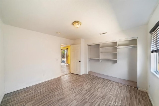 13969 Chervil Ct, Moreno Valley, CA 92553 - unfurnished bedroom with a closet and wood finished floors