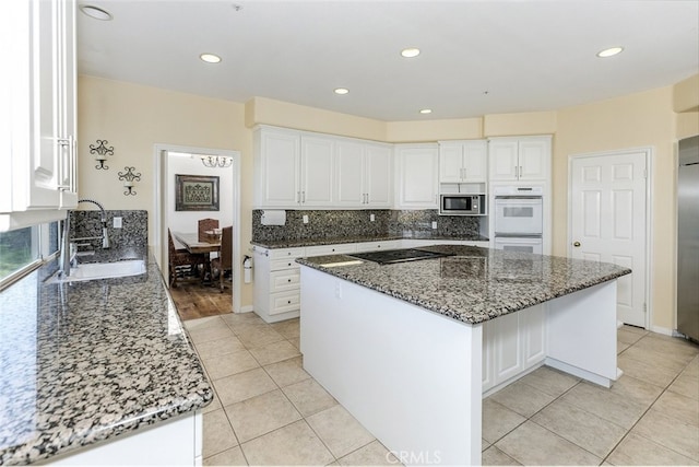 24736 Wooded Vis, West Hills, CA 91307 - kitchen featuring stainless steel appliances, light tile patterned floors, dark stone counters, tasteful backsplash, and recessed lighting