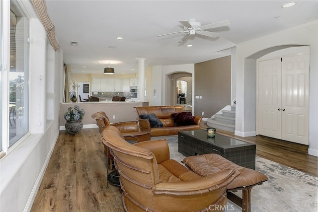 24736 Wooded Vis, West Hills, CA 91307 - living area featuring arched walkways, ceiling fan, wood finished floors, recessed lighting, and stairway