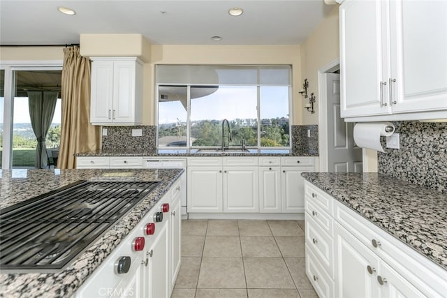 24736 Wooded Vis, West Hills, CA 91307 - kitchen with stainless steel gas cooktop, tasteful backsplash, dark stone counters, white cabinets, and recessed lighting