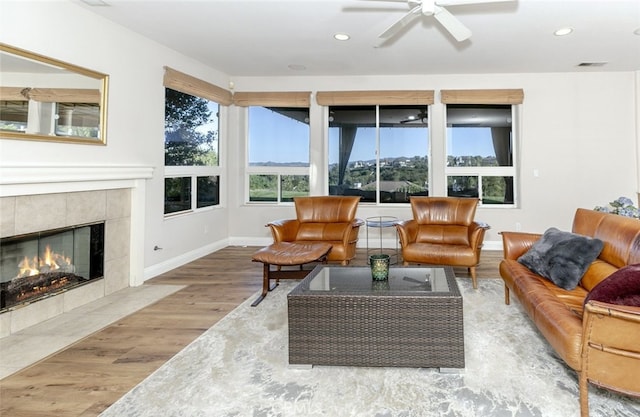 24736 Wooded Vis, West Hills, CA 91307 - living room featuring wood finished floors, a tiled fireplace, plenty of natural light, ceiling fan, and recessed lighting